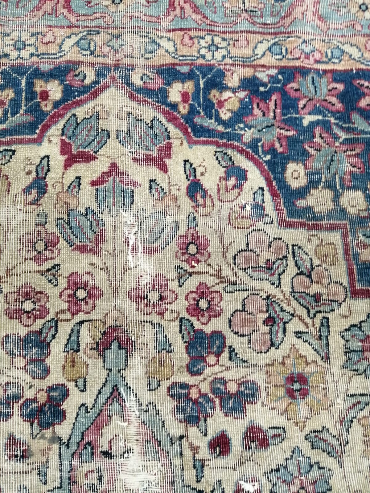 A Persian ivory ground carpet with central medallion of floral motifs, multi-bordered, 400 x 291cm